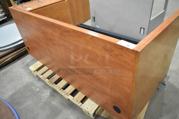 Wood pattern desk with two-drawer filing cabinet, featuring a smooth surface and attractive grain. Slight wear visible.