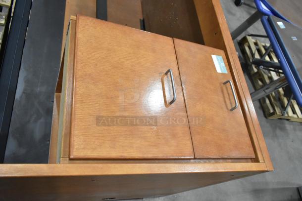 Wood pattern desk with two-drawer filing cabinet, metal handles, good condition. Label indicates office furniture.