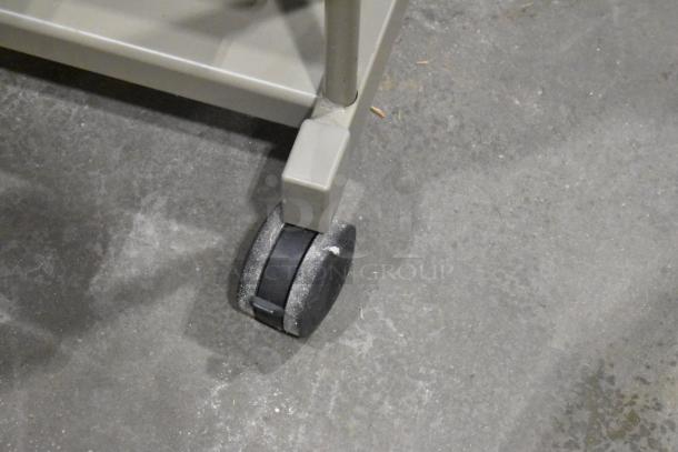 Three desks on casters, grey finish, featuring durable construction. Each desk includes smooth-rolling wheels for easy mobility.