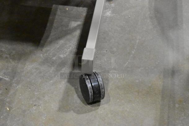 Three desks with casters, gray finish, sturdy construction, in good condition for easy mobility and versatile use.