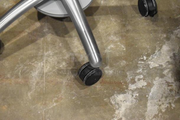 Portable stand with silver metal frame and black dual casters. Suitable for easy mobility. Good condition.