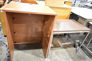 Two wood pattern items: a sturdy table with metal legs and a podium with cable cutout. Both are in good condition.