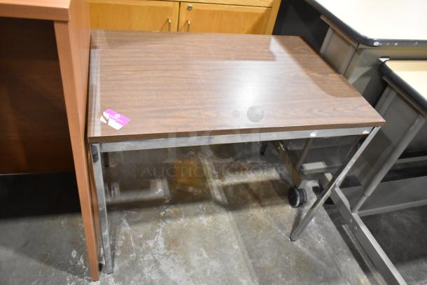 Wood pattern table with metal legs, in used condition. Visible tag on the table. Includes podium, sold as a pair.