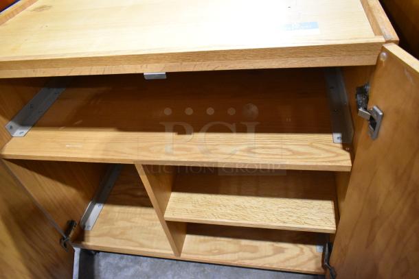 Wood pattern cabinet with two doors, shelves, and metal hinges, in good condition. Suitable for storage.