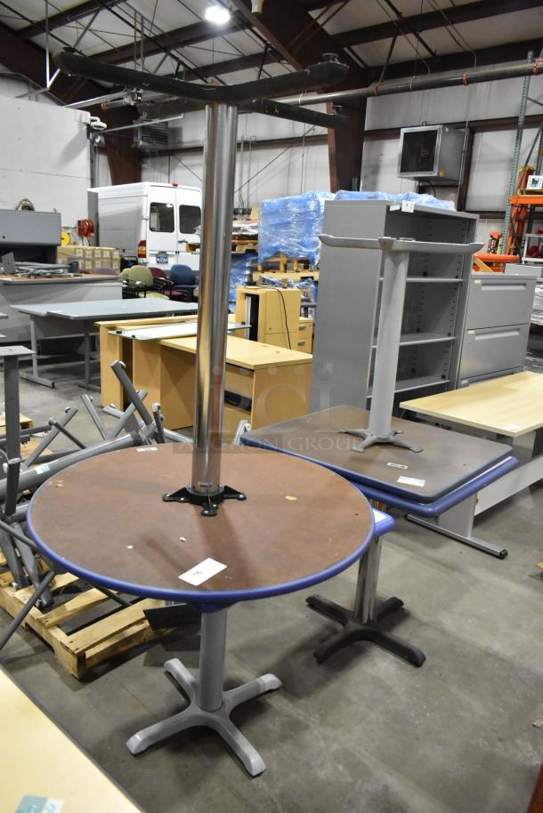 Four assorted tables, including a round and rectangular table, mixed materials, industrial setting; visible lot tags.