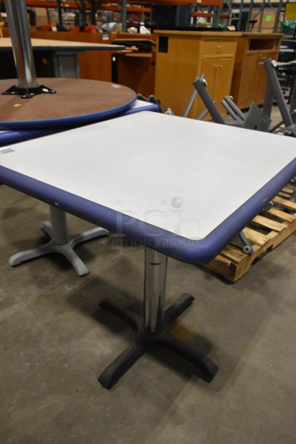 Four various tables, including round and rectangular, with metal bases. Mixed wood and laminate tops, good condition.