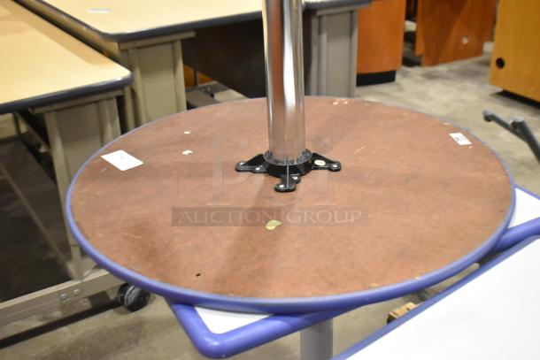 4 assorted tables including a round table with brown top and metal base. Visible wear. Auction lot labels attached.