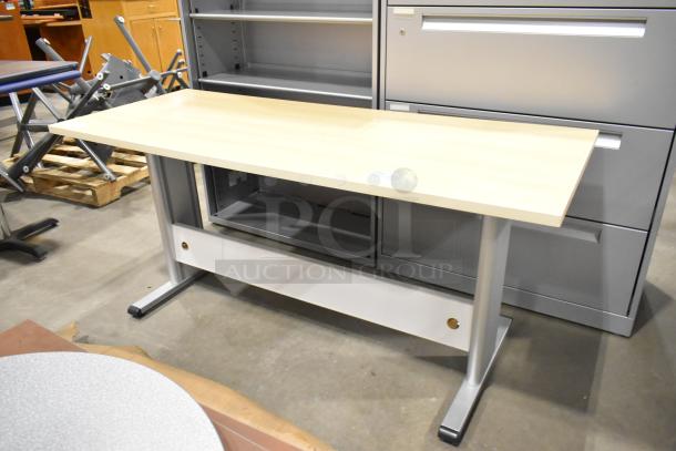 Wood pattern desk with a light finish, metal legs, and modesty panel. Excellent condition, suitable for office use.