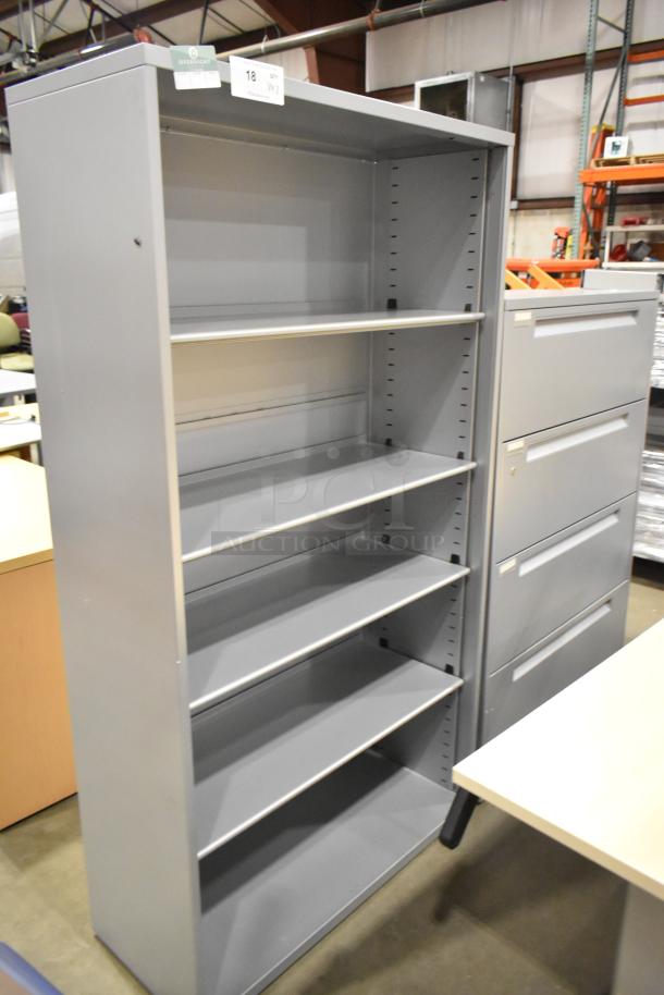 Gray metal bookshelf and 4-drawer filing cabinet. Both items in good condition. Bid includes two of each item.