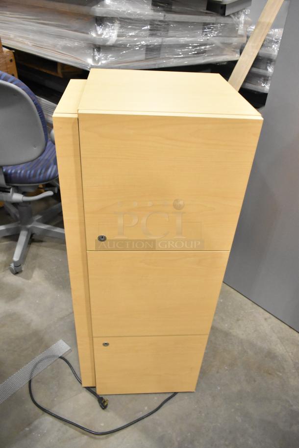 Wood pattern filing cabinet with three drawers. Light wood finish, modern design, key lock visible, good condition.