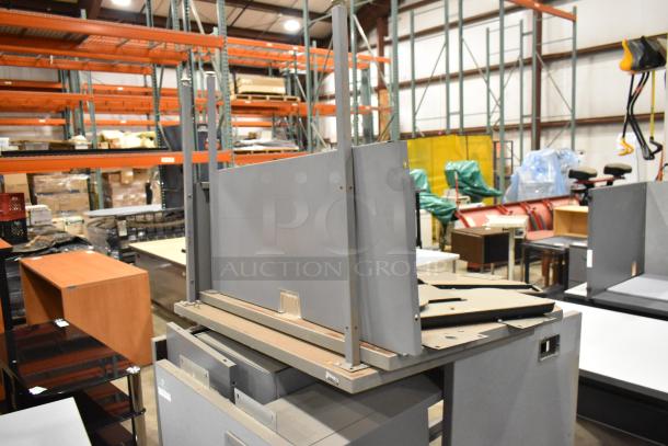 Gray desk set, disassembled, includes panels and hardware. Good condition, ideal for office setup.