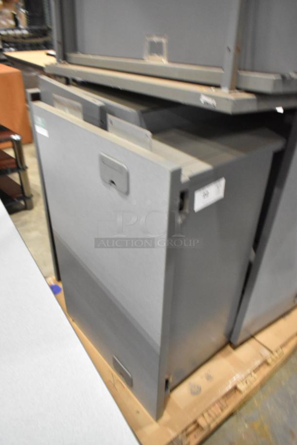 Gray desk set with storage units, showing minor wear. Features drawers and workspace, suitable for office use.