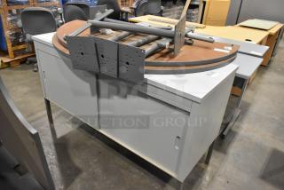 Metal 2-door cabinet with tabletop and legs; used condition. Includes two pieces, ideal for storage or workspace.