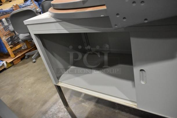 Metal cabinet with two sliding doors and tabletop, featuring sturdy legs; auction of two items for one bid.