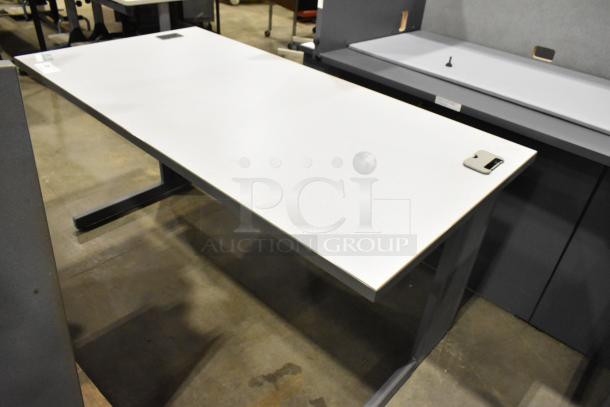 Modern gray desk with a spacious rectangular top, metal legs, and integrated cable management ports. Excellent condition.