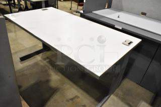 Modern gray desk with a spacious rectangular top, metal legs, and integrated cable management ports. Excellent condition.