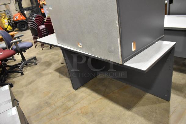 Gray two-piece desk, rectangular design, minor wear visible, suitable for office use.