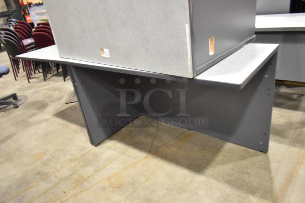 Gray desk in two pieces, featuring sturdy construction and a smooth surface. Suitable for office use, in good condition.