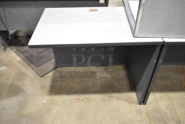 Gray desk in two pieces, minimalist design, with a light gray surface and sturdy dark gray legs. Good condition.