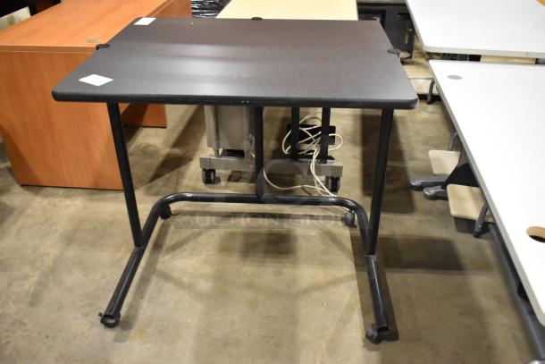 Four various desks and tables in a lot, featuring different styles and colors. Overall good condition, some with cable holes.