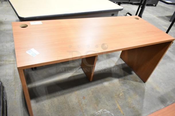 Wood pattern desk with smooth surface and two cable management holes, excellent condition, label with item details visible.