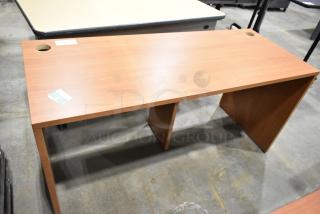 Wood pattern desk with smooth surface and two cable management holes, excellent condition, label with item details visible.