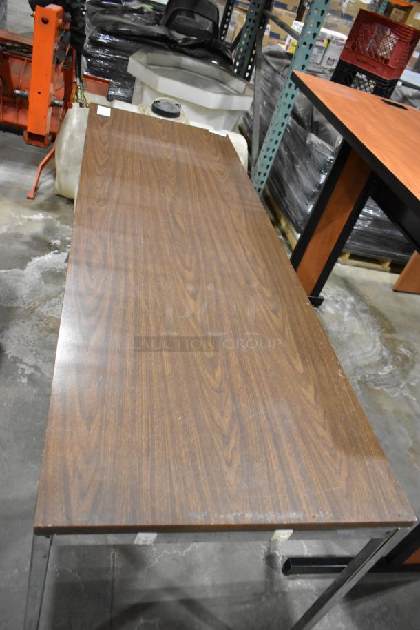 Two wood-patterned items including a table with a metal frame, showcasing signs of wear, suitable for utility use.