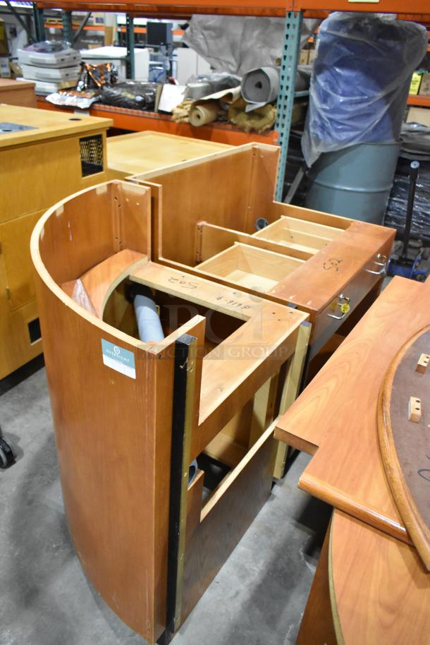 Wood pattern desk set up, featuring multiple compartments and curved design. Markings indicate assembly instructions. Moderate wear visible.