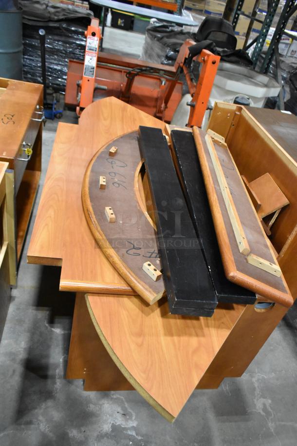 Wood pattern desk set up, disassembled, features curved sections with hardware pieces. Some wear visible, ideal for restoration. Marked "G 16".
