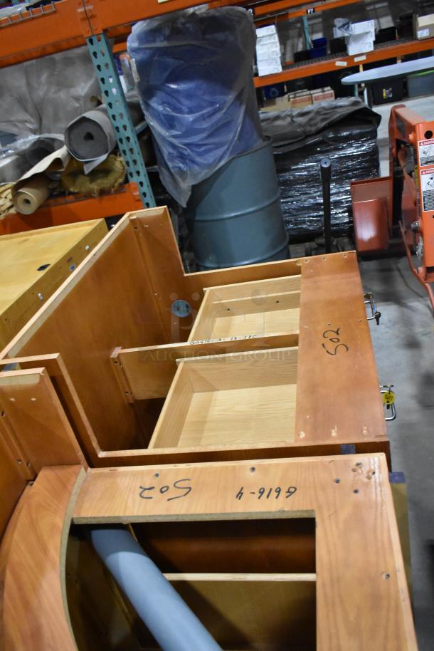 Wood pattern desk set with open compartments, visible wood grain, labeled "502" and "4-9199," in warehouse setting, good condition.