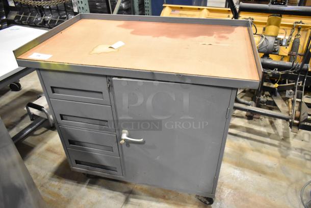 Gray metal cart with 4 drawers, a door, and commercial casters. Some surface wear visible, keys included.