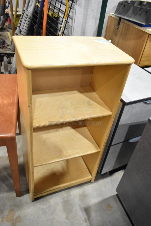 Wood pattern bookshelf with three shelves. Slight wear on edges. Part of a lot with desk on casters and table.