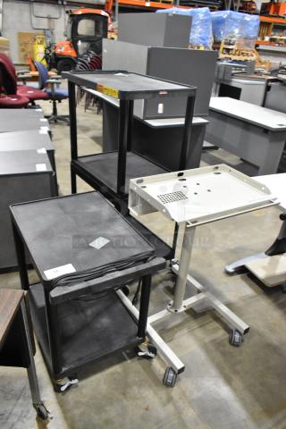 Three mobile carts on casters, including two black AV carts and one beige cart, in used condition.