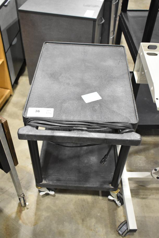 Three carts on casters, includes two AV carts, black, sturdy, with visible power cords, suitable for equipment transport.