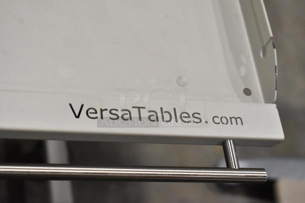Three carts on casters, including two AV carts by Versatables. White finish with metal handles, durable construction.