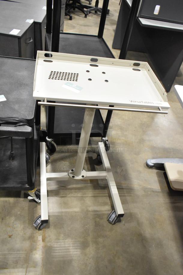 3 carts on casters, including 2 AV carts. Metal frames, rolling wheels, adjustable shelves. Branded VersaTables.