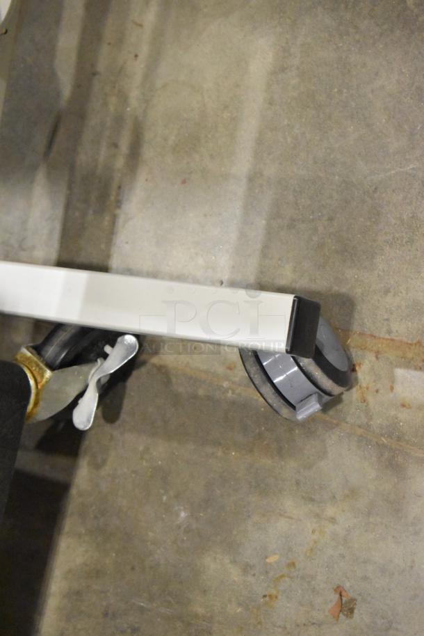 Three carts on casters, including two AV carts. Features visible gray wheels and metal frame. Appears in used condition.