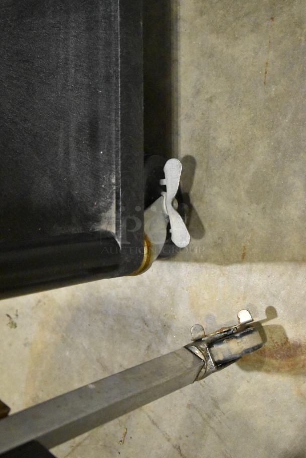 Three carts on casters, including two AV carts. Visible casters and metal frame. Good condition. Auction item.