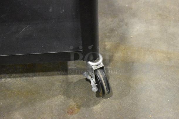 Three black carts with sturdy casters, including two AV carts. Visible caster lock marked "ON" for secure positioning.