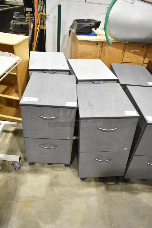 4 gray 2-drawer filing cabinets on casters. Features include metal handles and label holders. Good condition.