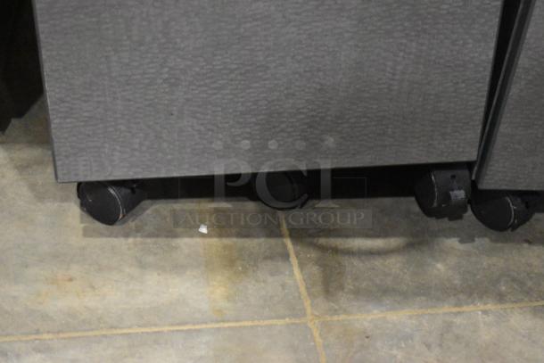 Four gray 2-drawer filing cabinets on casters, various designs, sturdy metal construction, some wear visible on surfaces.