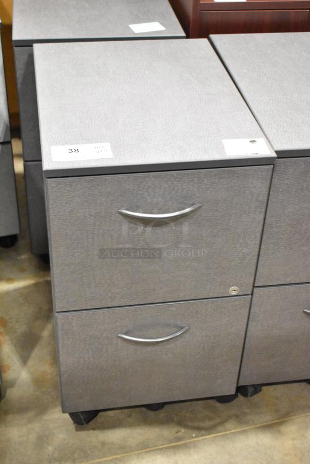 Four items including three gray 2-drawer filing cabinets on casters and a wood-pattern 2-door cabinet. Labels indicate "Qty. 4."