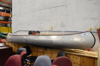 12' Grumman 13 CANOE metal canoe in good condition with oar and life jacket. Features Grumman logo.