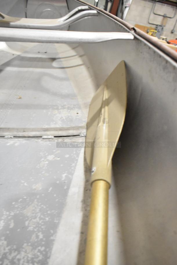12' Grumman 13 CANOE metal canoe with oar. Features include aluminum construction, visible wear consistent with use.