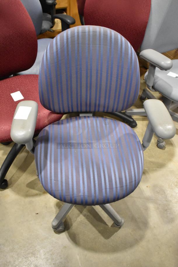 10 office chairs on casters in various colors; striped pattern shown. Good condition, some wear visible. Tags present.