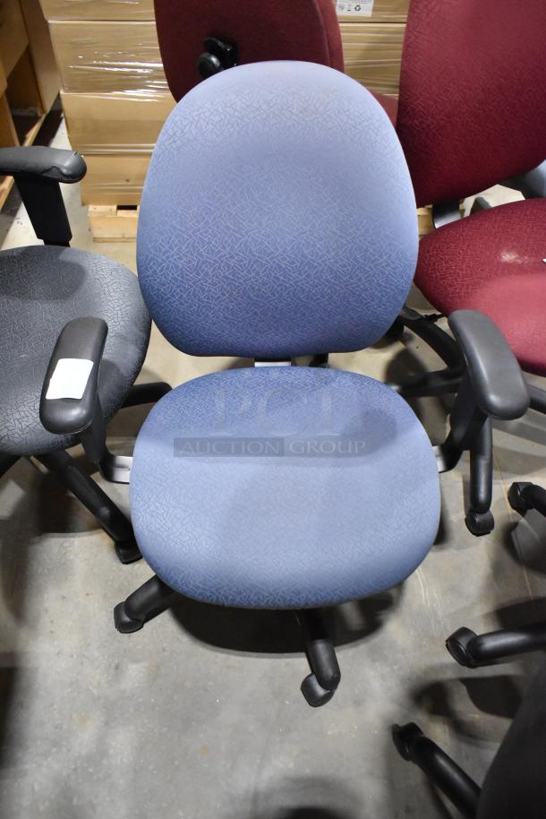 Ten assorted office chairs with casters, various colors and fabrics, in used condition, some armrests with labels.