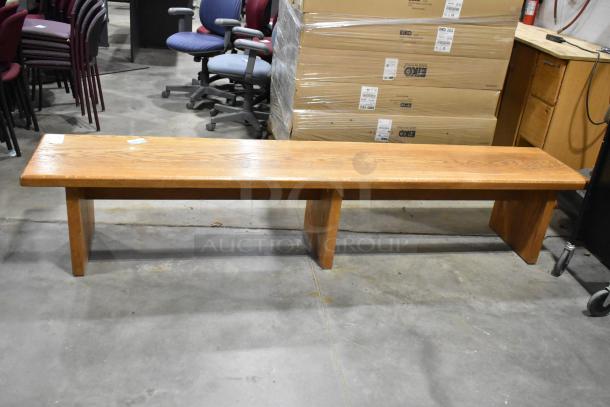 Wood pattern bench with a sleek finish, solid construction, and visible grain details. Excellent condition.