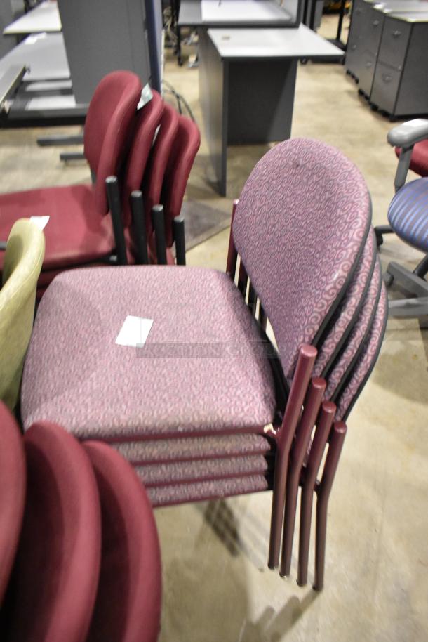 Stacked office chairs, various colors and designs, good condition. Includes 28 chairs total, each with patterned upholstery.