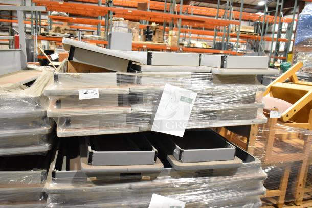 Stack of 29 gray folding tables, wrapped in plastic. Labels indicate lot number and auction details. Tables appear in good condition.