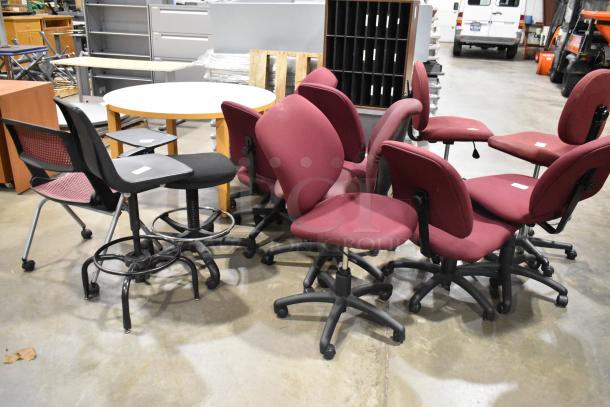 Twelve assorted office chairs, including maroon chairs with casters, in used condition. Includes bid for all chairs.